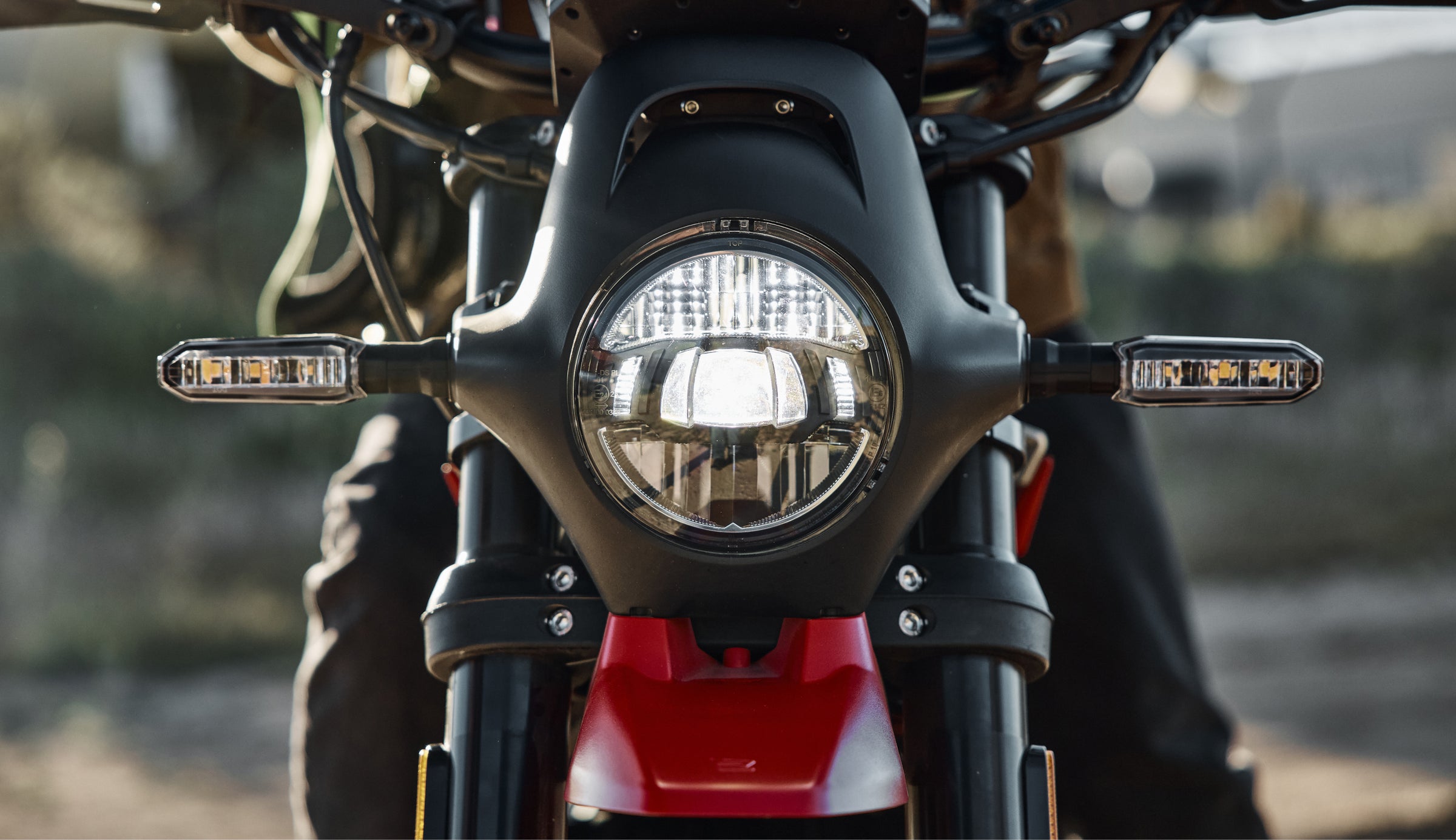 Ryvid electric motorcycle riding at dusk